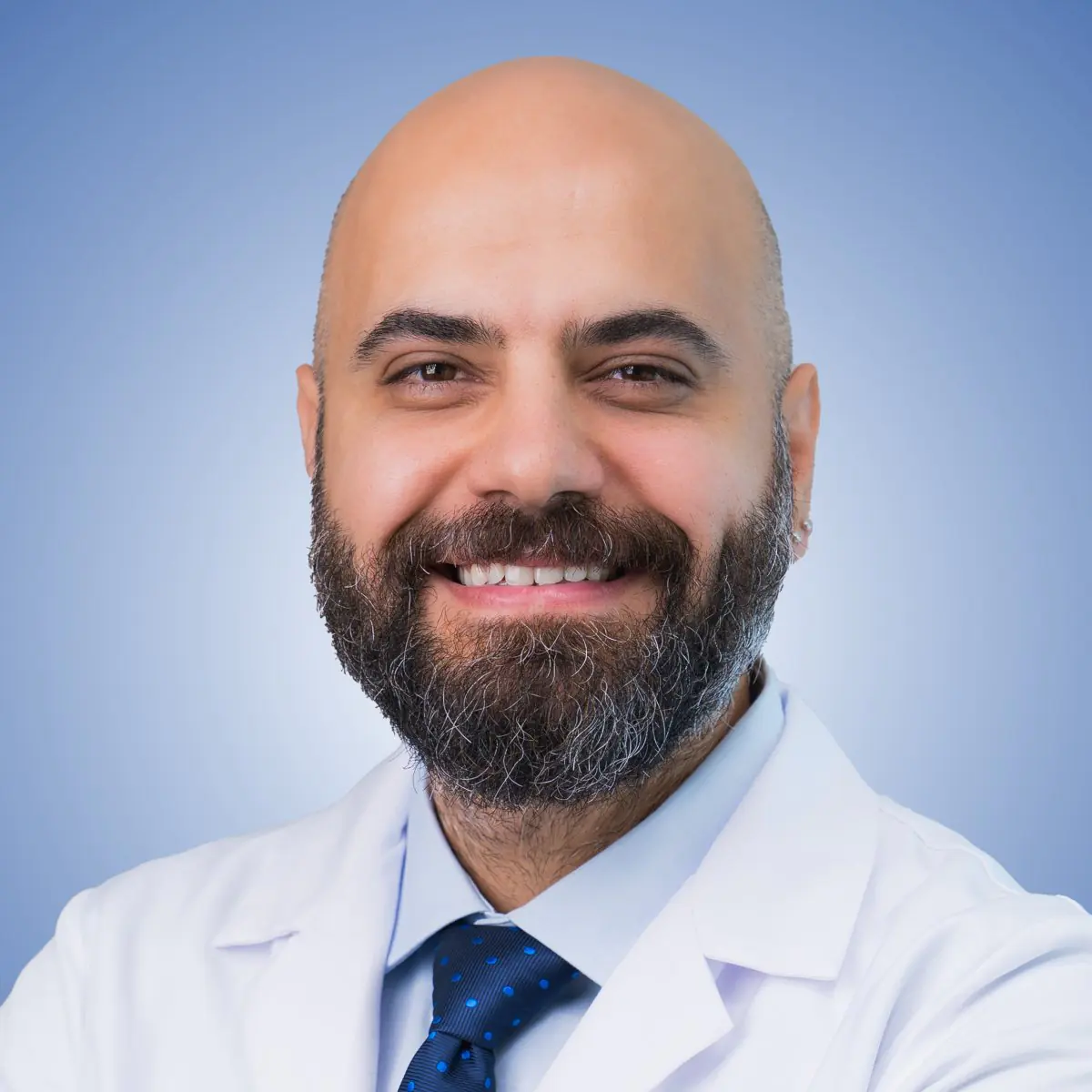 Smiling clinician in a white coat shown on the Uroaesthetic Bookimed clinic profile